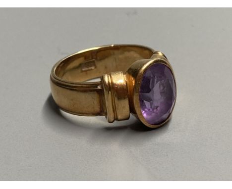 A 1950's? 585 yellow metal and amethyst set dress ring, size K, gross 7.3 grams.CONDITION: Minor nicks and scratches to the s