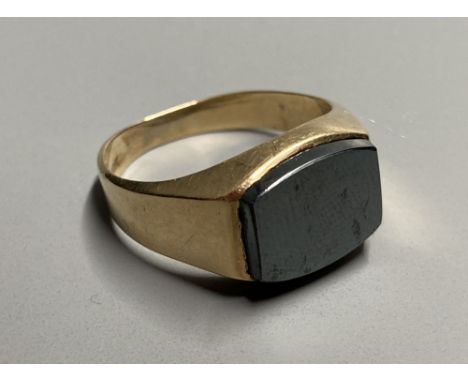 A modern 10k yellow metal and hematite set signet ring, size Q, gross 5.8 grams.CONDITION: Minor scratches to the shank, othe