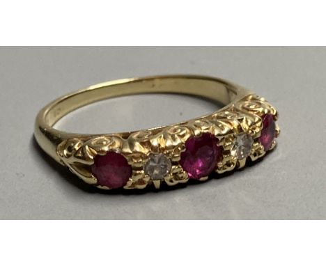 An 18ct Victorian style two stone diamond and three stone ruby set half hoop ring, size K/L. gross 3.1 grams.CONDITION: Marks