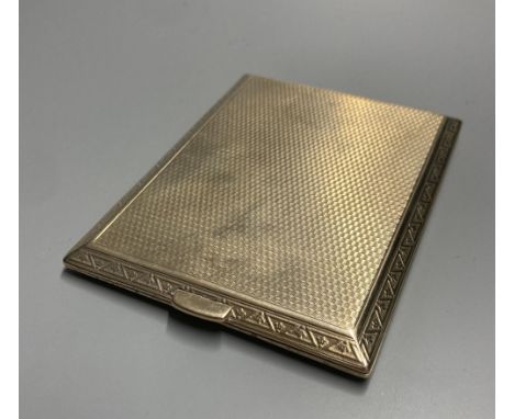 A late 1920's 9ct gold engine-turned cigarette case, with chased fleur-de-lys border, inscribed to interior, 11.3cm, gross 14