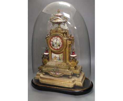 A 19th century French Louis XV style gilt spelter and porcelain mounted eight day mantel clock, on plinth, under a glass dome