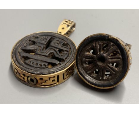 An unusual Chinese pierced gilt metal and base metal inset ring, size P, and matching pendant, overall 53mm.