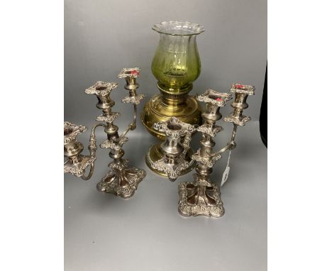 A pair of plated two branch candelabra and a brass oil lamp (3)