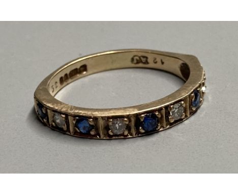 A modern 9ct gold, sapphire and diamond set nine stone half hoop ring, size L, gross 2.3 grams.CONDITION: A couple of very mi