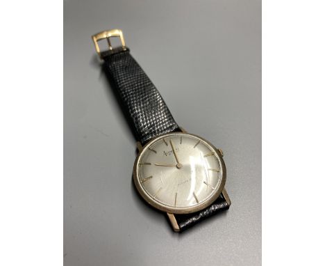 A gentleman's 9ct gold Accurist shockmaster manual wind wrist watch, on associated strap, gross 21.5 grams, case diameter 33m