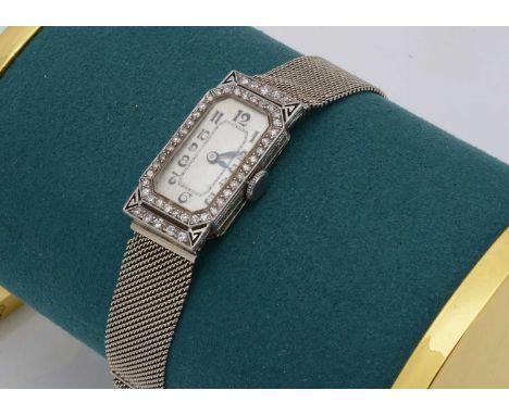 A c1950s platinum and diamond lady's cocktail dress wristwatch case, 14.4cm wide, on a later 18ct white gold mesh link bracel