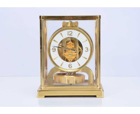 A Jaeger-LeCoultre Atmos VIII brass and glazed mantle clock, 22cm high, with white outer dial having partial numerals and arr