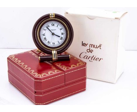 A modern Must de Cartier cased travel clock, in maroon and in red and gilt box with outer card boxPlease see additional image