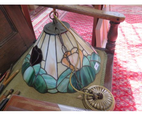 A stained glass ceiling light shade, with floral motif on a beige and green ground, 41 cm diameter 