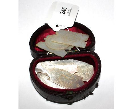 Ten Victorian mother of pearl gaming counters, and a magic lantern lens, 5.5 cm diameter 