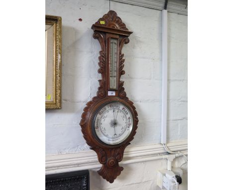 A carved oak banjo barometer, with thermometer and aneroid dial, 87 cm high 