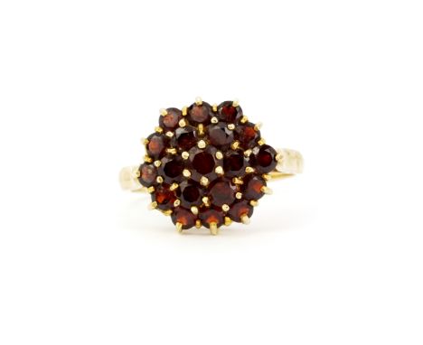 A 9ct yellow gold cluster ring set with round cut garnets, (P).