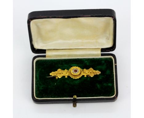 A boxed Edwardian 15ct yellow gold brooch set with rose cut diamonds and ruby, L. 4.2cm.