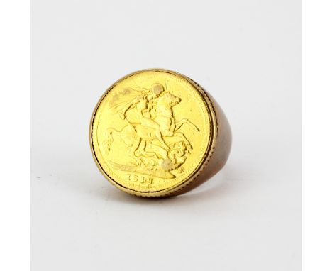A 9ct yellow gold mounted sovereign ring, (Q), ring shank off shape, c. 1913, approx. 16gr.