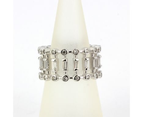 A 925 silver three tiered full eternity ring set with round and baguette cut cubic zirconia's, (N).