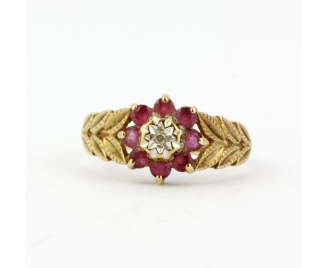 A hallmarked 9ct yellow gold ring set with round cut rubies and a diamond, (M.5).