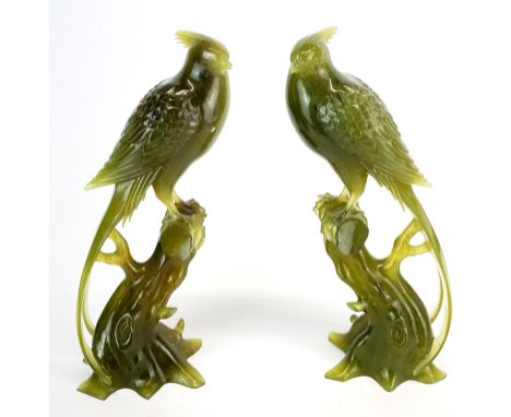 A fine pair of Chinese carved jade figures of phoenix  with carved wooden bases, (one base missing a foot), height without ba