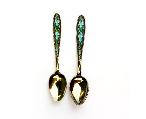 A pair of Russian Leningrad silver gilt and enamalled spoons, L. 12cm.