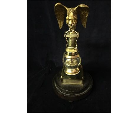 An interesting thermometer with a figure of an eagle on top and stand