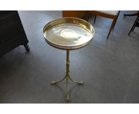 A Victorian brass tripod wine table