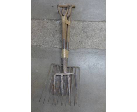 A hay fork, shovel and a garden fork