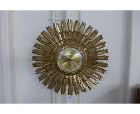An American Syroco Brutalist 8-day sunburst wall clock