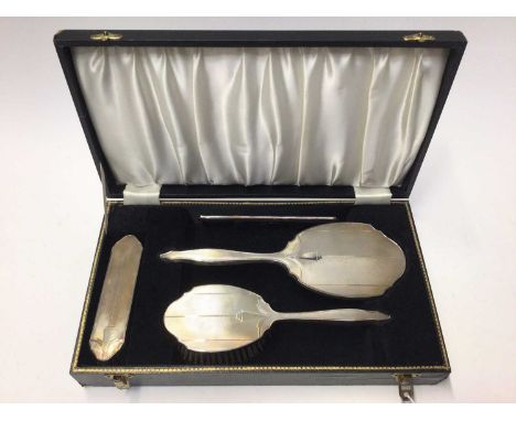 1960's silver backed hand mirror, brushes and comb set, with engine turned decoration, (Birmingham 1967), in fitted case