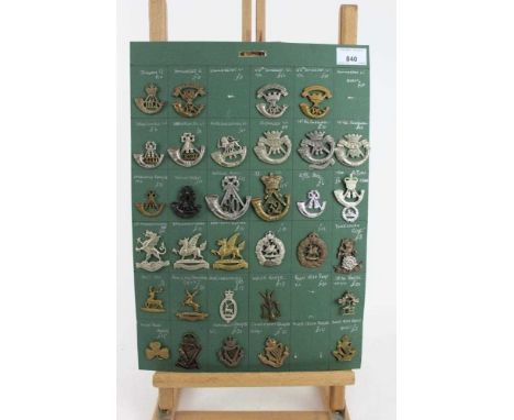Four boards mounted with British military cap badges, various regiments including Connaught Rangers, Somerset Light Infantry 