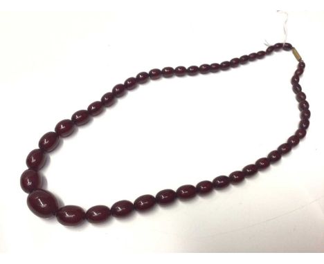 Art Deco simulated cherry amber bead necklace, 59cm.Gross weight approximately 34 gramsOverall good condition. One bead has a