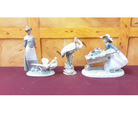 Seven Lladro and Nao porcelain figures including girl pushing a Wheelbarrow with two dogs inside itAll in good condition apar