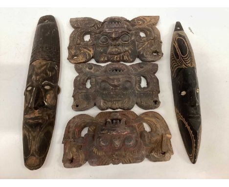 Quantity of African masks, together with an African elder's chair, a bow, arrow and spear, together with three Indian temple 