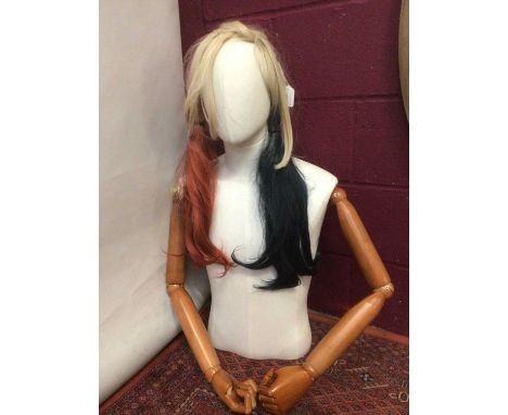 Shops mannequin torso with jointed arms and wig.