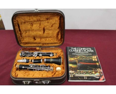 Corton clarinet in case, together with a lesson book