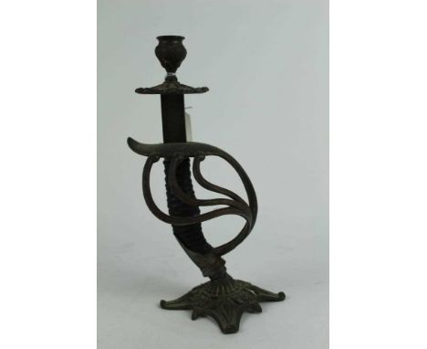 Interesting brass candlestick constructed from an Imperial German sword hilt, 28.5cm in overall height