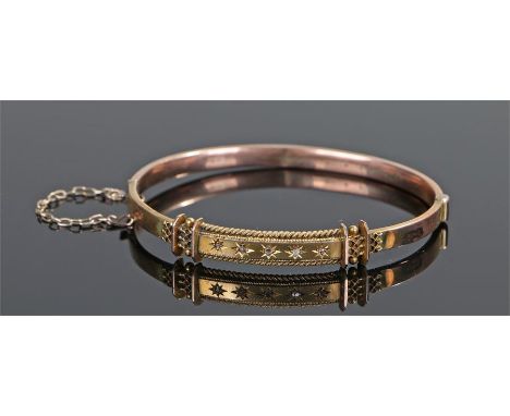 Yellow metal and diamond set bangle, with five diamonds set into star mounts, 6.7 grams