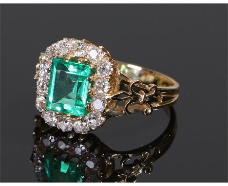 Colombian emerald and diamond set ring, the central emerald at 1.23 carat in size, insignificant indications of clarity enhan