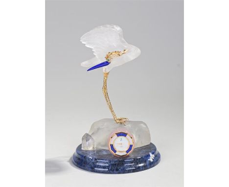 Gem set desk clock, the clock with a rock crystal carved stork with a diamond, emerald, sapphire and ruby set head with a lap