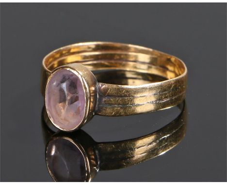 19th Century yellow metal ring, set with a pale purple stone, ring size R