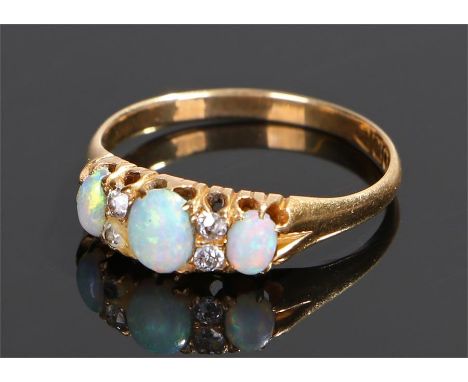 18 carat gold opal and diamond ring, the head set with three oval opals and four round cut diamonds, ring size S