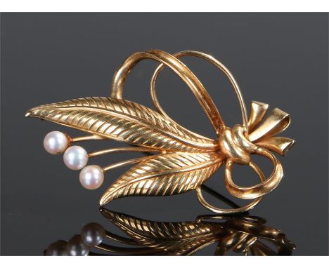 18 carat gold pearl set brooch, in the form of bow tied leaves with pearl berry heads, 47mm long