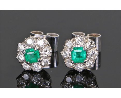 Pair of emerald and diamond set earrings, with a central emerald to each and diamond surround, each 9mm in diameter 