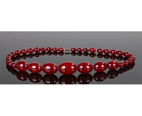 Art Deco cherry Bakelite amber necklace, with a row of graduated beads, the largest bead 31mm long