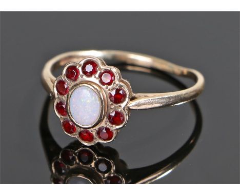 9 carat opal and garnet set ring, with a central oval opal and garnet surround, ring size S