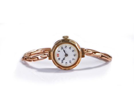 9 carat gold ladies wristwatch, with a white enamel dial and Arabic hours, 9 carat gold elasticated strap, the case 23mm diam
