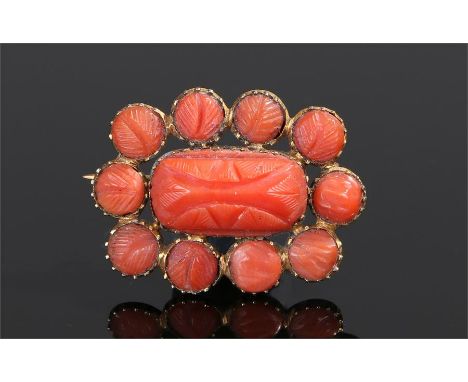 Victorian coral brooch, the central carved brooch with conforming carved coral surround, 25mm length