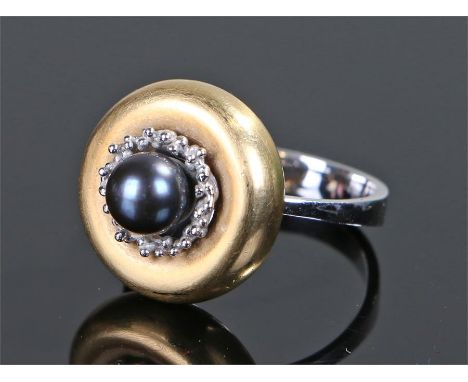 18 carat white and yellow gold pearl set ring, the black pearl centre with a yellow gold surround and white gold shank, ring 