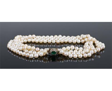 Pearl, diamond and emerald necklace, the three strand pearl necklace with an emerald cut emerald clasp and diamond surround