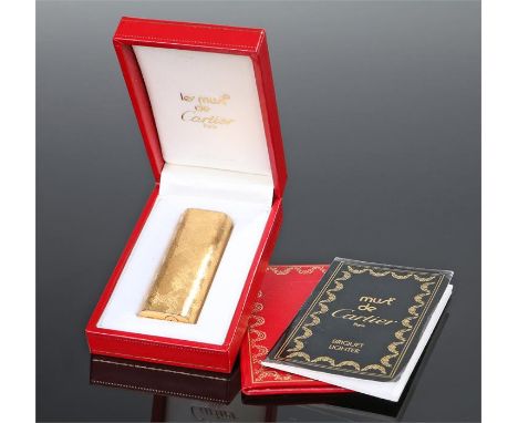 Cartier gilt metal lighter, Must Be Cartier, with an engine turned case, cased together with paperwork