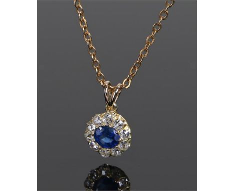 Sapphire and diamond pendant necklace, the central sapphire with a diamond surround, the pendant 8mm diameter 