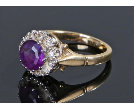 18 carat gold amethyst and diamond set ring, the central amethyst with a diamond surround, ring size Q